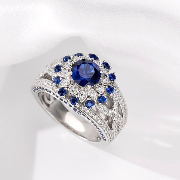 Sunflower Halo Round Cut Blue Sapphire Engagement Ring in Sterling Silver