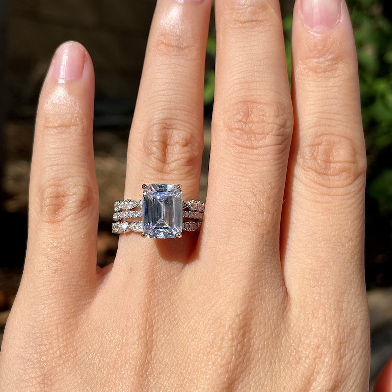 Help! I need wedding band ideas for my emerald cut solitaire engagement ring.  Ring in photo with 1 band option. Can I see some other emerald cut  solitaires with wedding bands ? :
